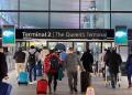 Passengers with luggage arriving at London Heathrow Airport Terminal 2.